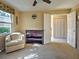 Cozy bedroom with a serene ambiance and ample natural light from a window and sliding glass door at 821 Waterside Dr # 106, Venice, FL 34285