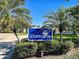 Landscaped Waterside community sign amidst palm trees, welcoming residents and visitors at 821 Waterside Dr # 106, Venice, FL 34285