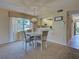 Charming dining area with a decorative chandelier and a view to the kitchen at 821 Waterside Dr # 106, Venice, FL 34285