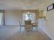 Dining area featuring a chandelier, carpeted floors, and a view of the backyard at 821 Waterside Dr # 106, Venice, FL 34285