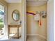 Foyer area with tile flooring, closet and a console table with a mirror at 821 Waterside Dr # 106, Venice, FL 34285
