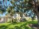 Exterior view showing well-manicured lawn and mature landscaping at 821 Waterside Dr # 106, Venice, FL 34285