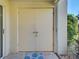 Close up of the double front doors with a doormat and an adjacent window at 821 Waterside Dr # 106, Venice, FL 34285