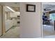 Galley kitchen with white cabinetry and a pass-through to the living space at 821 Waterside Dr # 106, Venice, FL 34285