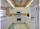 Well lit kitchen featuring white cabinetry and stainless-steel appliances at 821 Waterside Dr # 106, Venice, FL 34285