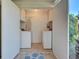 Compact laundry room featuring a washer, dryer, and upper cabinets for storage at 821 Waterside Dr # 106, Venice, FL 34285