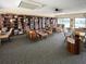 The library contains bookshelves filled with books, tables and chairs for reading and studying at 821 Waterside Dr # 106, Venice, FL 34285