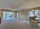 Spacious living room featuring large windows and sliding glass doors that fill the space with natural light at 821 Waterside Dr # 106, Venice, FL 34285