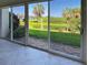 Serene patio view showcasing palm trees, waterfront scenery, and lush greenery at 821 Waterside Dr # 106, Venice, FL 34285