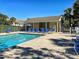 Community pool and grilling area with ample seating for residents to enjoy the outdoors at 821 Waterside Dr # 106, Venice, FL 34285