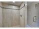 Updated shower featuring neutral tiling and mosaic accents at 821 Waterside Dr # 106, Venice, FL 34285