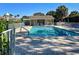 Community pool with lounge chairs and a cabana area for relaxation and leisure at 821 Waterside Dr # 106, Venice, FL 34285