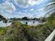 A community swimming pool with lounge chairs and umbrellas, surrounded by green foliage at 821 Waterside Dr # 106, Venice, FL 34285