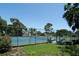 Fenced tennis courts offer a recreational amenity for residents of Bird Bay Village at 821 Waterside Dr # 106, Venice, FL 34285