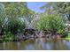 Scenic waterfall feature surrounded by lush greenery within the Bird Bay Village community at 821 Waterside Dr # 106, Venice, FL 34285