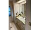 Bathroom featuring a vanity with marbled design and a window with natural light at 902 Jolanda Cir, Venice, FL 34285