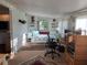 Bedroom with daybed, computer desk, and a sunny window overlooking the exterior at 902 Jolanda Cir, Venice, FL 34285