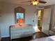 Bedroom featuring a dresser with mirror and view into the bathroom at 902 Jolanda Cir, Venice, FL 34285