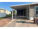 Covered carport with painted turtle art and a bicycle parked, providing shaded parking and outdoor space at 902 Jolanda Cir, Venice, FL 34285