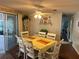 Cozy dining area with a spacious table setting, sliding doors and natural light at 902 Jolanda Cir, Venice, FL 34285