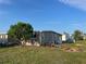 A single-story home with green space in the yard, and landscaped with stones and plants at 902 Jolanda Cir, Venice, FL 34285
