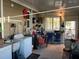 View of the garage showing laundry machines, storage shelves and items stored in the garage at 902 Jolanda Cir, Venice, FL 34285