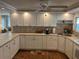 Bright kitchen featuring white cabinetry, modern countertops, and a ceiling fan at 902 Jolanda Cir, Venice, FL 34285