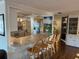 Open kitchen with a breakfast bar featuring counter seating and a view into the dining and living areas at 902 Jolanda Cir, Venice, FL 34285