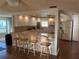Bright kitchen with white cabinetry, modern countertops, and a breakfast bar at 902 Jolanda Cir, Venice, FL 34285