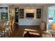 Spacious living room with built-in shelving, a television, and a view of the breakfast bar at 902 Jolanda Cir, Venice, FL 34285