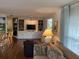 Cozy living room featuring built-in shelving, a television, and comfortable seating with good lighting at 902 Jolanda Cir, Venice, FL 34285