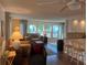 Inviting living room with wood floors, neutral decor, and an abundance of natural light from the many windows at 902 Jolanda Cir, Venice, FL 34285