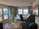 Bright home office space with hardwood floors, a comfortable futon, and a vintage wood secretary desk at 902 Jolanda Cir, Venice, FL 34285