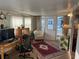 Sun room area features a comfortable chair, desk, and sunny windows at 902 Jolanda Cir, Venice, FL 34285