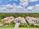 Aerial view of the home showcasing its location, tile roof, and beautiful landscaping at 9048 Luna Ln, Sarasota, FL 34241