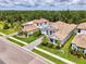 An aerial shot of a beautiful home in a lush green area, featuring a tile roof at 9048 Luna Ln, Sarasota, FL 34241
