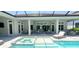 Stunning backyard with a private pool, spa, and covered patio, ideal for outdoor entertaining and relaxation at 9048 Luna Ln, Sarasota, FL 34241