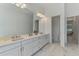 Bright bathroom with double sinks, quartz countertop and vanity, and modern fixtures at 9048 Luna Ln, Sarasota, FL 34241