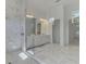 Spacious bathroom featuring double vanity sinks, marble floors, and a glass-enclosed shower at 9048 Luna Ln, Sarasota, FL 34241