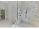 Luxurious bathroom featuring a glass-enclosed shower with elegant marble tiling and modern fixtures at 9048 Luna Ln, Sarasota, FL 34241