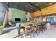 Open-concept clubhouse with a long bar table, modern decor, and a spacious seating area at 9048 Luna Ln, Sarasota, FL 34241