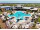 Stunning aerial view of the community pool area, highlighting the slides, lounge chairs, and landscaping at 9048 Luna Ln, Sarasota, FL 34241