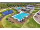 A serene community pool surrounded by palm trees and lounge chairs, perfect for relaxation at 9048 Luna Ln, Sarasota, FL 34241