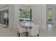 Bright dining area features a white table and chairs with a view of the pool at 9048 Luna Ln, Sarasota, FL 34241
