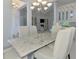 Formal dining room with updated light fixture, a decorative table, and seating with views into the living room at 9048 Luna Ln, Sarasota, FL 34241