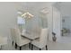 A formal dining room features updated light fixtures, neutral wall colors, and natural light at 9048 Luna Ln, Sarasota, FL 34241