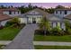 Stunning home featuring a paved driveway, lush landscaping, and a tile roof at 9048 Luna Ln, Sarasota, FL 34241