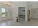 Elegant foyer featuring an ornate chandelier, showcasing a view into a side room, and tile flooring throughout at 9048 Luna Ln, Sarasota, FL 34241