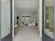 Welcoming foyer featuring sleek tile floors, a glimpse of the open-concept living area, and an abundance of natural light at 9048 Luna Ln, Sarasota, FL 34241