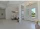 Bright foyer with high ceilings, an ornate chandelier, and an entryway into the dining room with a nearby sitting room at 9048 Luna Ln, Sarasota, FL 34241